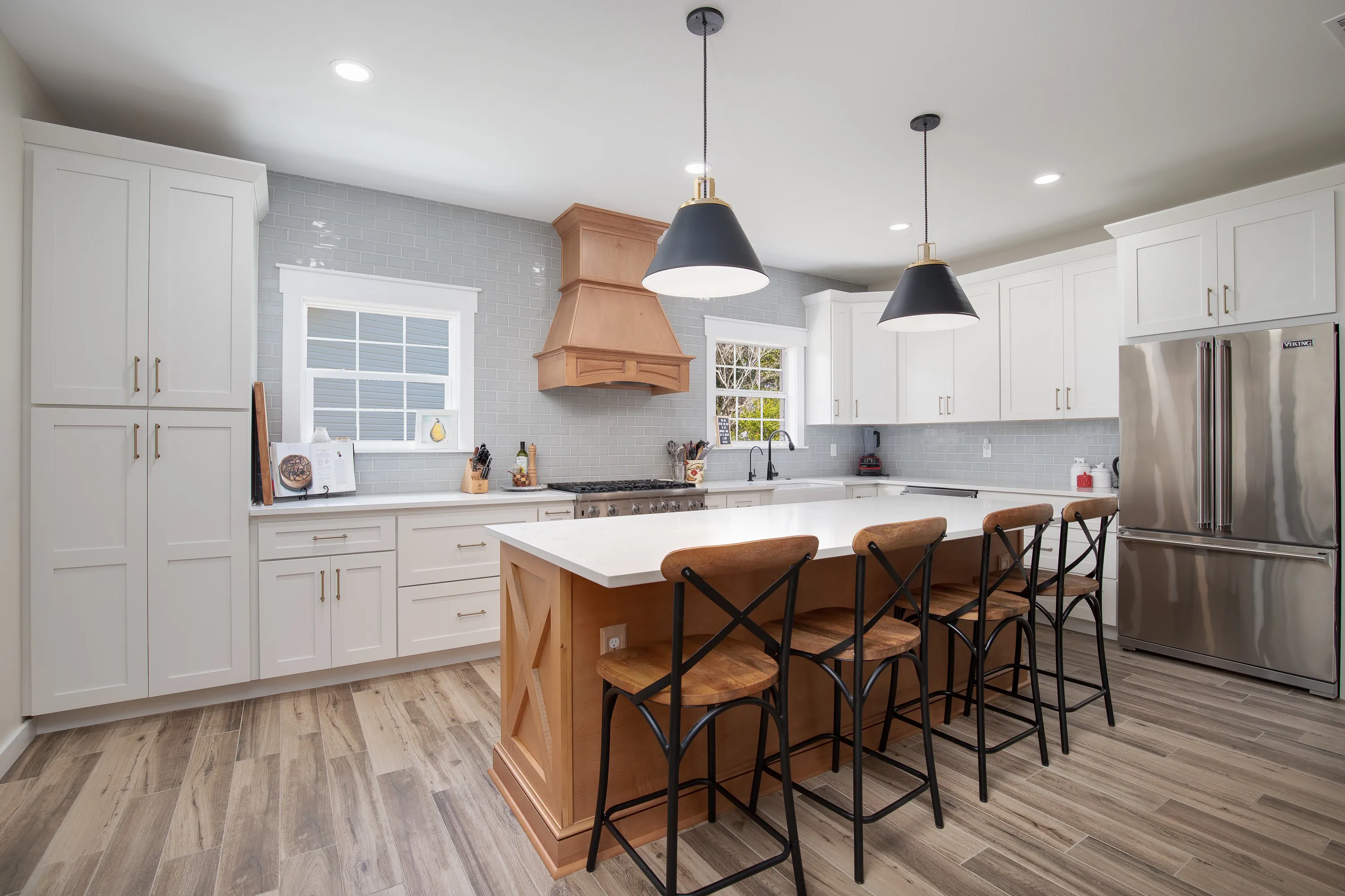 Custom white shaker kitchen with center island and copper range hood